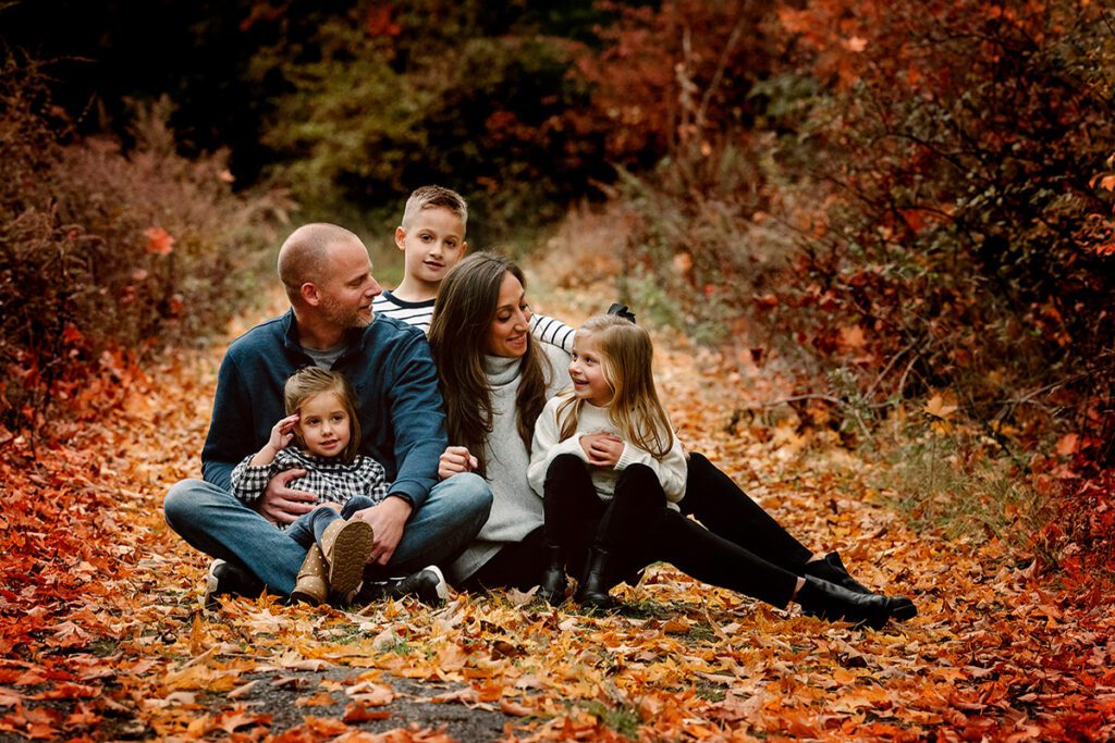 A Family Sitting on the Forest Floor