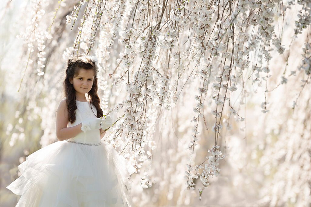 A Little Girl Dressed in a White Color Gown