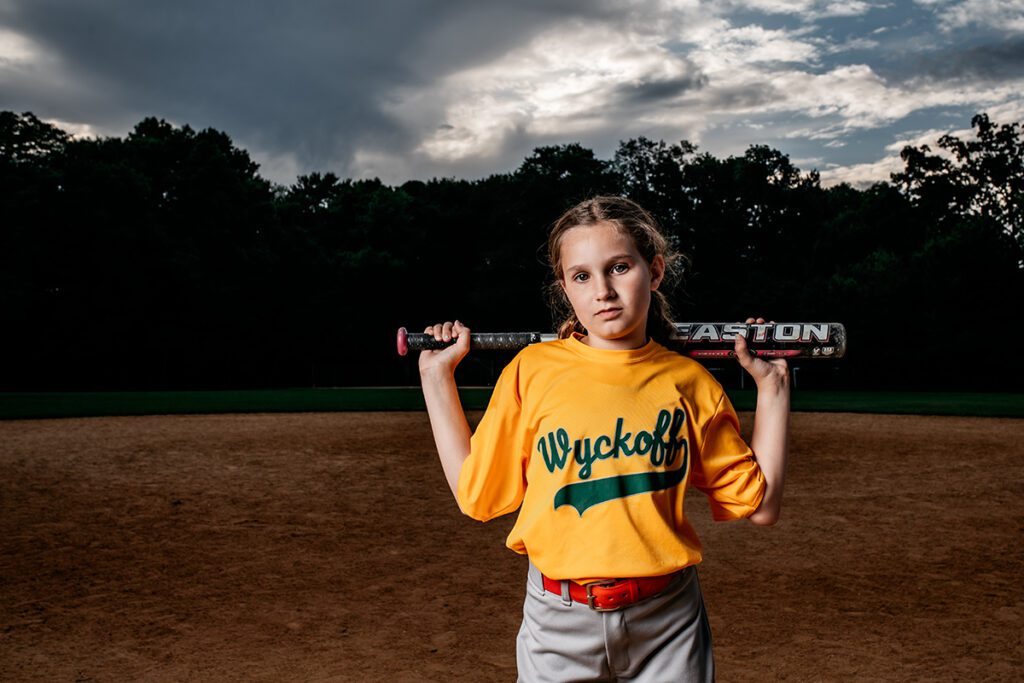 Northern New Jersey Softball Photographer photographs player in field with bat